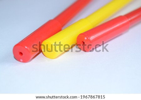 abstract background with outlines of colored ballpoint pens with white areas