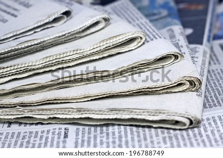 newspapers against plain background shot with very shallow depth of field Royalty-Free Stock Photo #196788749