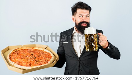 Pizza time. Italian food. Smiling man with delicious pizza and cold beer. Fast Food. Restaurant or pizzeria.