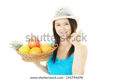 Smiling woman with fruits.
