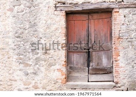 Old wooden door. An old and dilapidated wooden door in an old house in Tuscany.