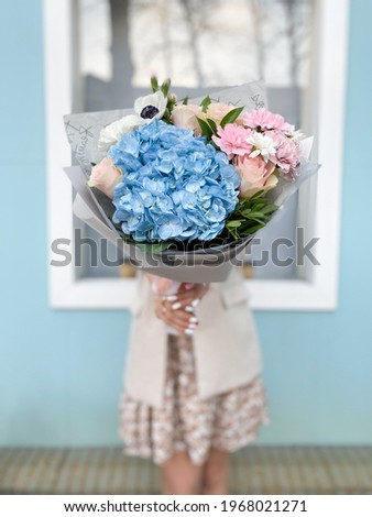a girl holds a bouquet of flowers
