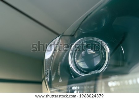 detail of modern car projector headlight, shallow depth of field, filter effect