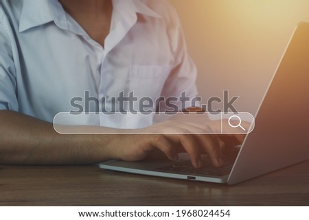 Hand businessman using laptop at home office workplace. Blank search bar webpage with browser of Internet data background. Searching on web search SEO engine network concept. Business technology .