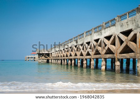 The concrete bridge juts into the sea. 
Pier bridge background picture. 