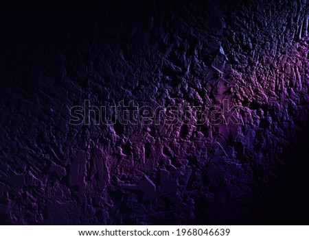 The stone wall highlighted with a bit of purple
