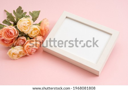 Bouquet of roses and white picture frame