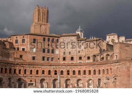 Beautiful view of Rome in Italy. Ancient historical ruins of architectural landmark of western culture. The Roman Forum buildings, columns, and temples on a sunny day with blue sky and before a storm.