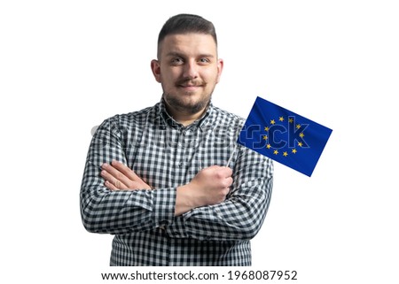 White guy holding a flag of European Union smiling confident with crossed arms isolated on a white background.