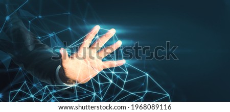 Businessman touching an abstract cloud with his hand on a dark background, technology and innovation concept