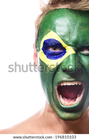 Soccer fan with brazil flag painted over face