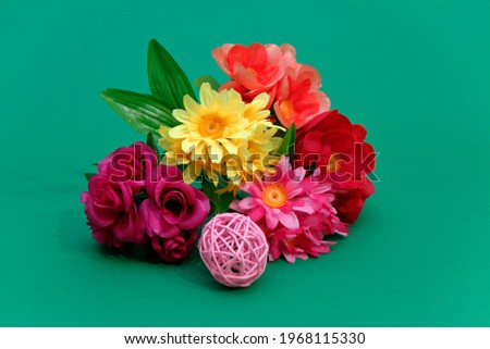 Beautiful roses, daisies. artificial flowers. for table decoration, holiday. on a green background. Valentine's Day. new Year. Christmas. birthday.