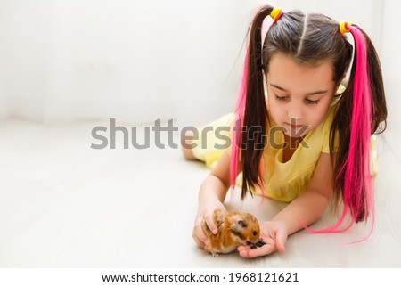 My little pal - girl holding her hamster in palms Royalty-Free Stock Photo #1968121621