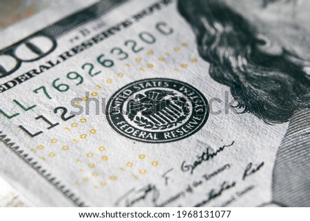 macro photo of federal reserve system symbol on one hundred dollar bill. shallow focus. close-up with fine and sharp texture