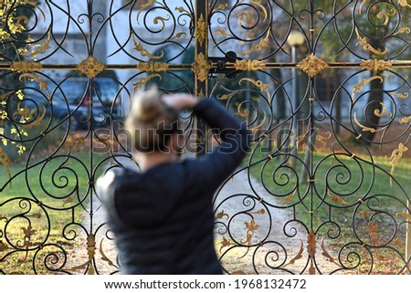 Autumn mood at the Attersee, a photographer takes a closeup picture of the entrance gate to castle Kammer