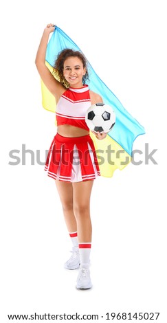 Beautiful young cheerleader with the flag of Ukraine and ball on white background