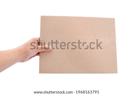 Cardboard sheet in the girl's hand isolated on a white background. Copy space. Place for your text. Royalty-Free Stock Photo #1968163795