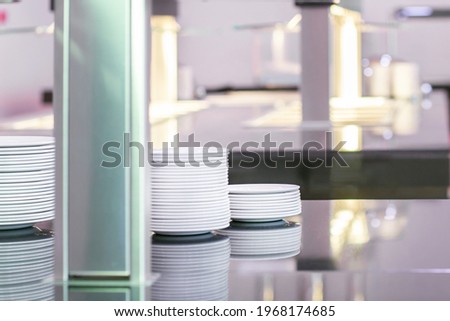 Plates on a metal countertop. Commercial kitchen