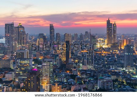 Sunset panorama aerial view in the middle of Bangkok cityscape skyline .Business area with office bluiding.Twilight sky landscape of capital city.Sunset light with beutiful sky.