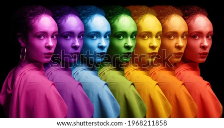 Beautiful African-American woman and her colorful energy fields on dark background