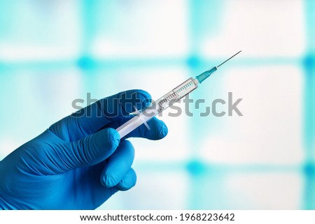 anesthetist in cosmetic surgery clinic with a syringe to anesthetize a patient before the intervention. Doctor preparing dose of vaccine in syringe for the vaccination plan against diseases Royalty-Free Stock Photo #1968223642