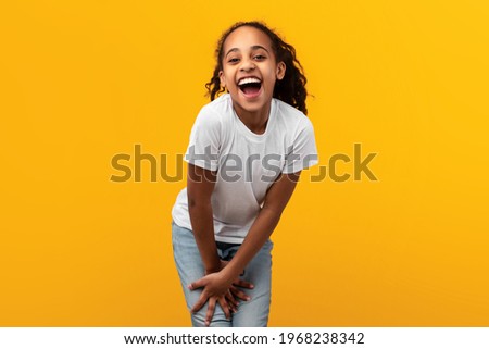 Portrait Of Cute Joyful African American Girl Laughing, Looking And Smiling At Camera, Young Child Posing Isolated Over Yellow Studio Background With Free Copy Space, Banner
