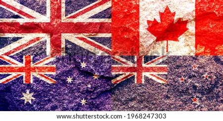 Vintage UK (United Kingdom), Canada, Australia and New Zealand national flags together on weathered solid rock wall background, abstract political alliance relationship concept