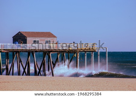 Telephoto shot of a fishing pier that juts out over the Atlantic Ocean in Belmar, NJ.