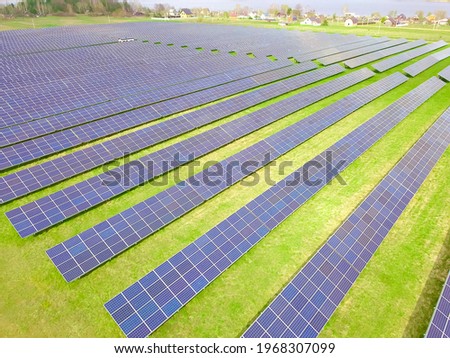Drone view of a solar power plant on a sunny day. Solar farm system with a drone. A source of ecological renewable energy
