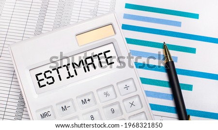 Against the background of reports and blue graphs, a pen and a white calculator with a test on the ESTIMATE screen. Business concept