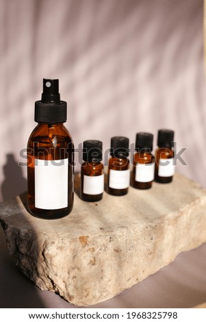 different cosmetics products on rock, Essential oils or face toner samples