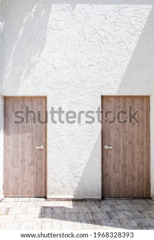 Two wooden doors matching the white wall, high resolution photo editing image source Book cover design recommendation Synthetic source