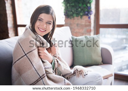 Photo of lovely girl covered with checkered blanket sit divan in living room