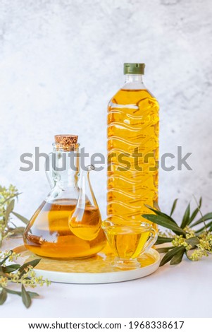 Olive branch and olive oil bottle isolated on white.