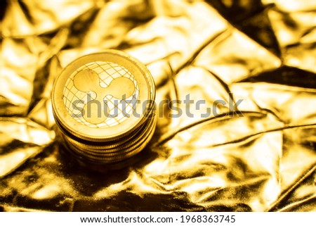 Gold Ripple coins on a golden background. Trading on the cryptocurrency exchange. Cryptocurrency Stock Market Concept. Virtual money concept. Mining or blockchain technology. Business concept.