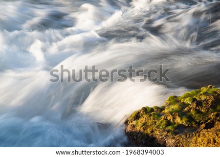 Motion blur of  moving sea waves, slow shutter speed.