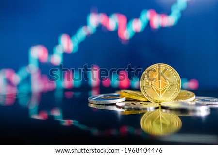 Ethereum (ETH) and other crypto coins with blurred candlestick chart. Ethereum is a decentralized, open-source blockchain with smart contract. Cryptocurrency and decentralized finance concept Royalty-Free Stock Photo #1968404476