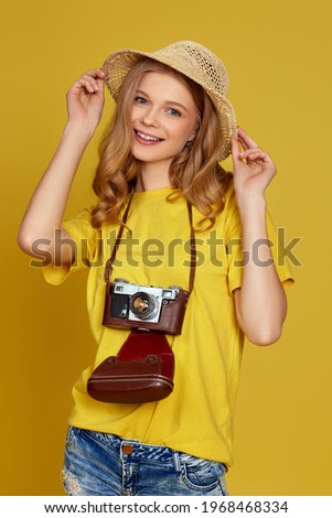 curly blonde woman holding retro vintage photo camera