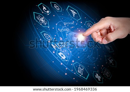 The man's hand pointed to press the center of the high-tech circle surrounded by medical icons. Definition of concept online health care, medical, science.Background blue light.