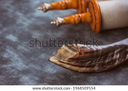 Shofar horn jewish religious holiday symbols on soft focus Jewish torah scroll Royalty-Free Stock Photo #1968509554