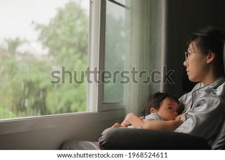 Tired Mother Suffering from experiencing postnatal depression.Health care single mom motherhood stressful. Royalty-Free Stock Photo #1968524611