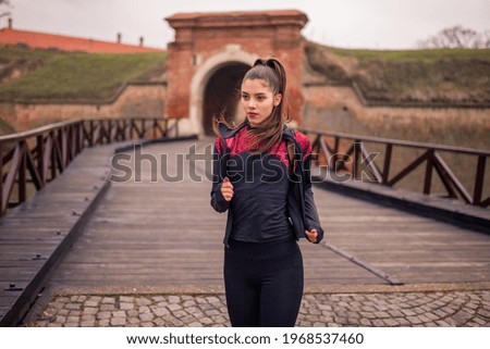 one young woman portrait, runner in winter.