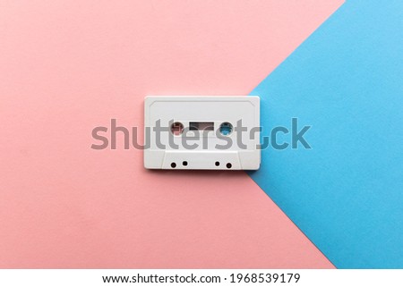 vintage white cassette tape on a blue and pink background