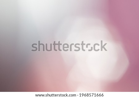 Gray-pink background with white bokeh. Horizontal picture.