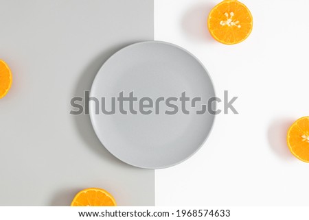 Half of orange on white and gray background. Flat lay, top view, copy space