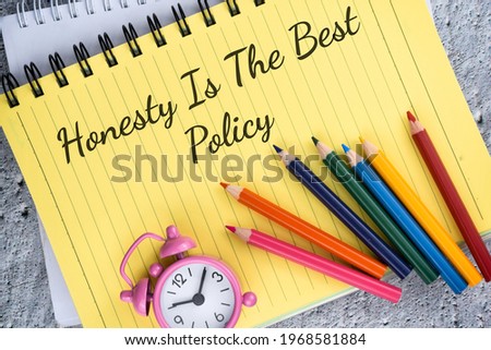 Honesty Is The Best Policy phrase with colorful pencil and clock over a yellow book. Selective focus image