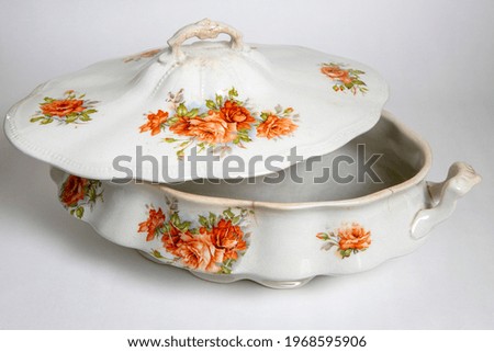 Antique porcelain tureen with flowers painted on a white background Royalty-Free Stock Photo #1968595906