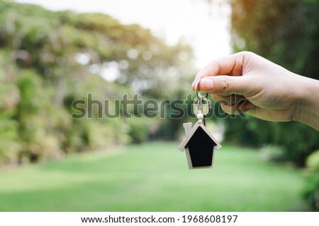 Men hand holding house key, real estate agent. Mortgage concept. Real estate, Buy sell, moving home, or renting property.