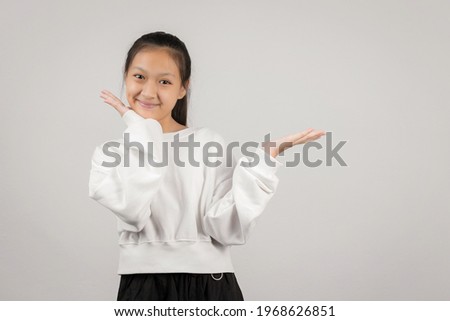 Asian little girl studio portrait on gray background