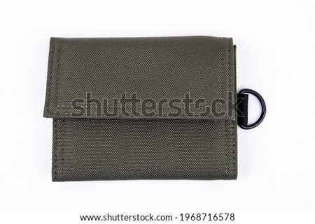 Green wallet on a white background. Fabric product.